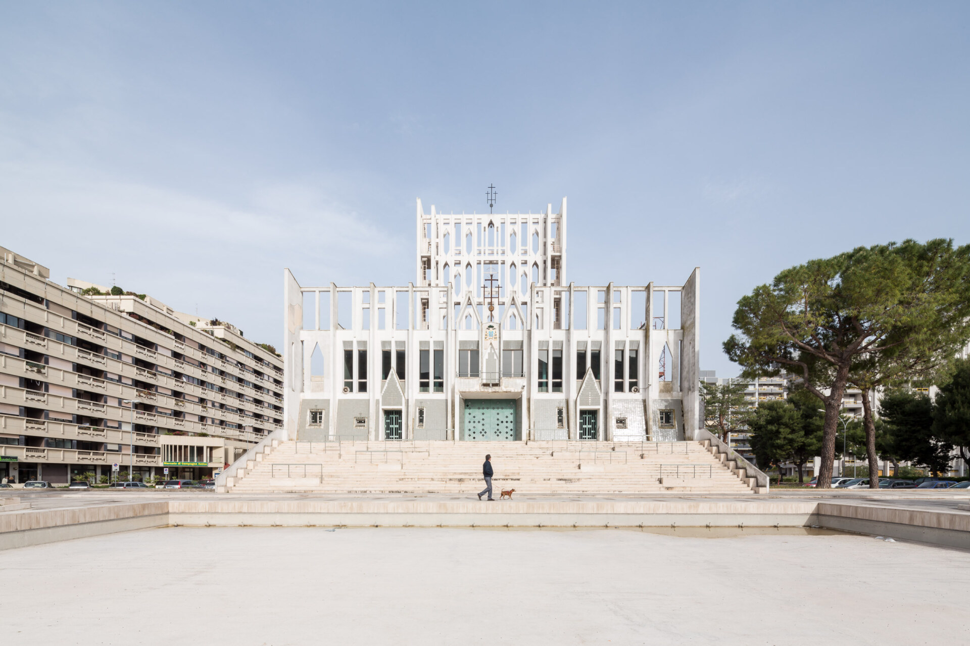 the front of the Co-Cathedral Gran Madre di Dio with a man walking his dog