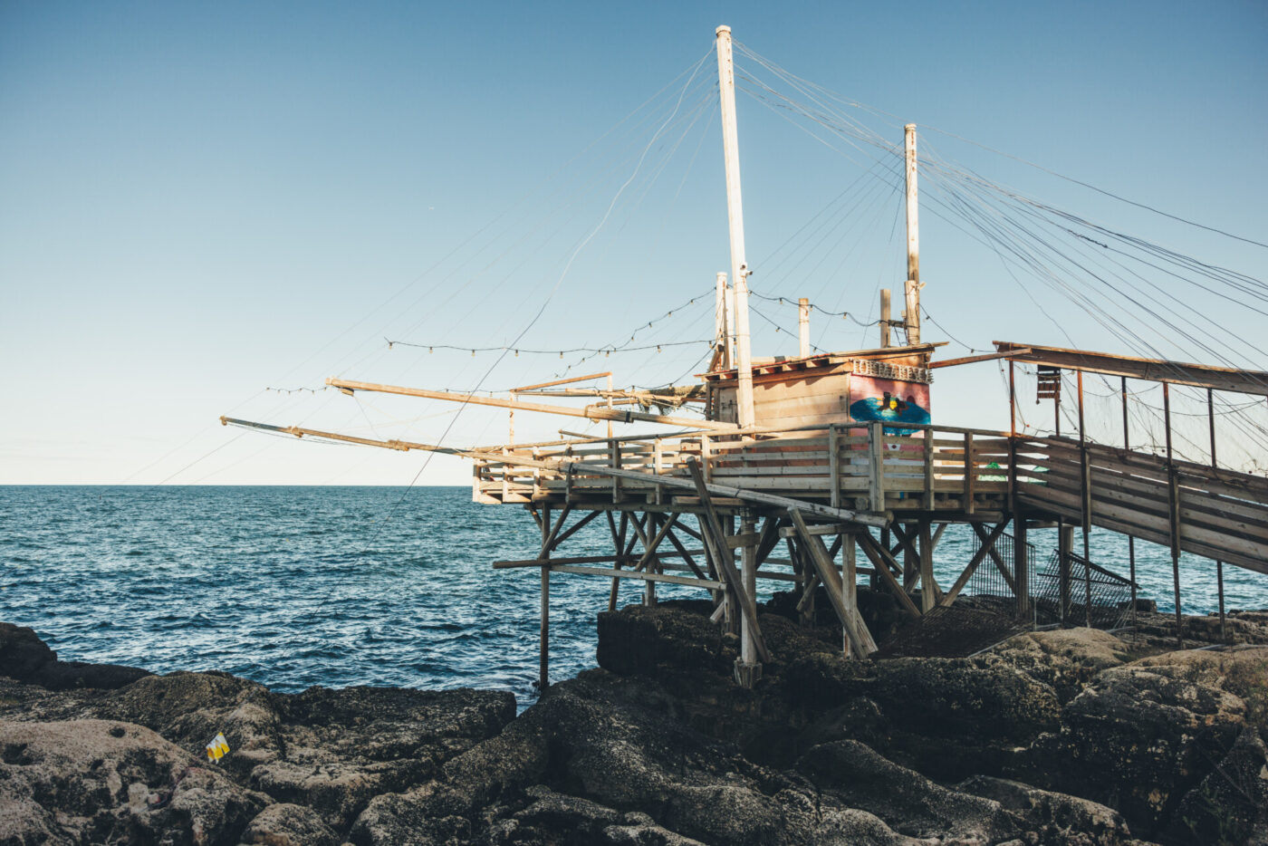 Trabucco Tormaresca photographed from afar hanging out over the water