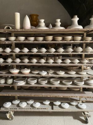 Francesco Fasano's studio in Grottaglie with shelves stacked with ceramics