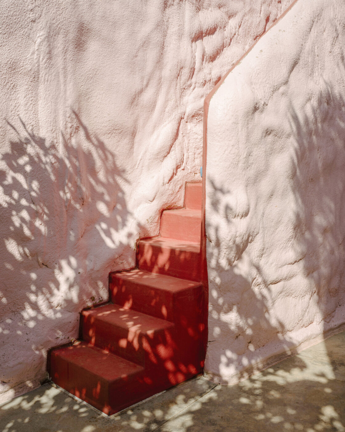 bright colored stairs against the light pink pescetrullo house