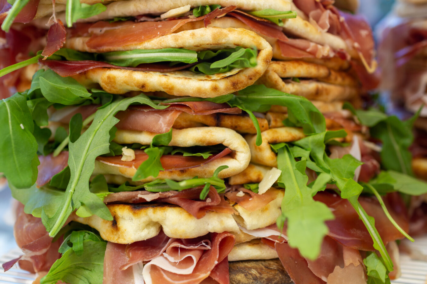 an image of stuffed piadina sandwiches with meat and arugula