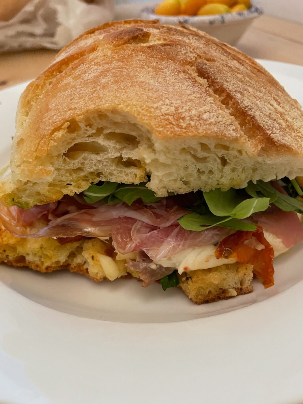 an image of a ciabatta sandwich with a bite out of it