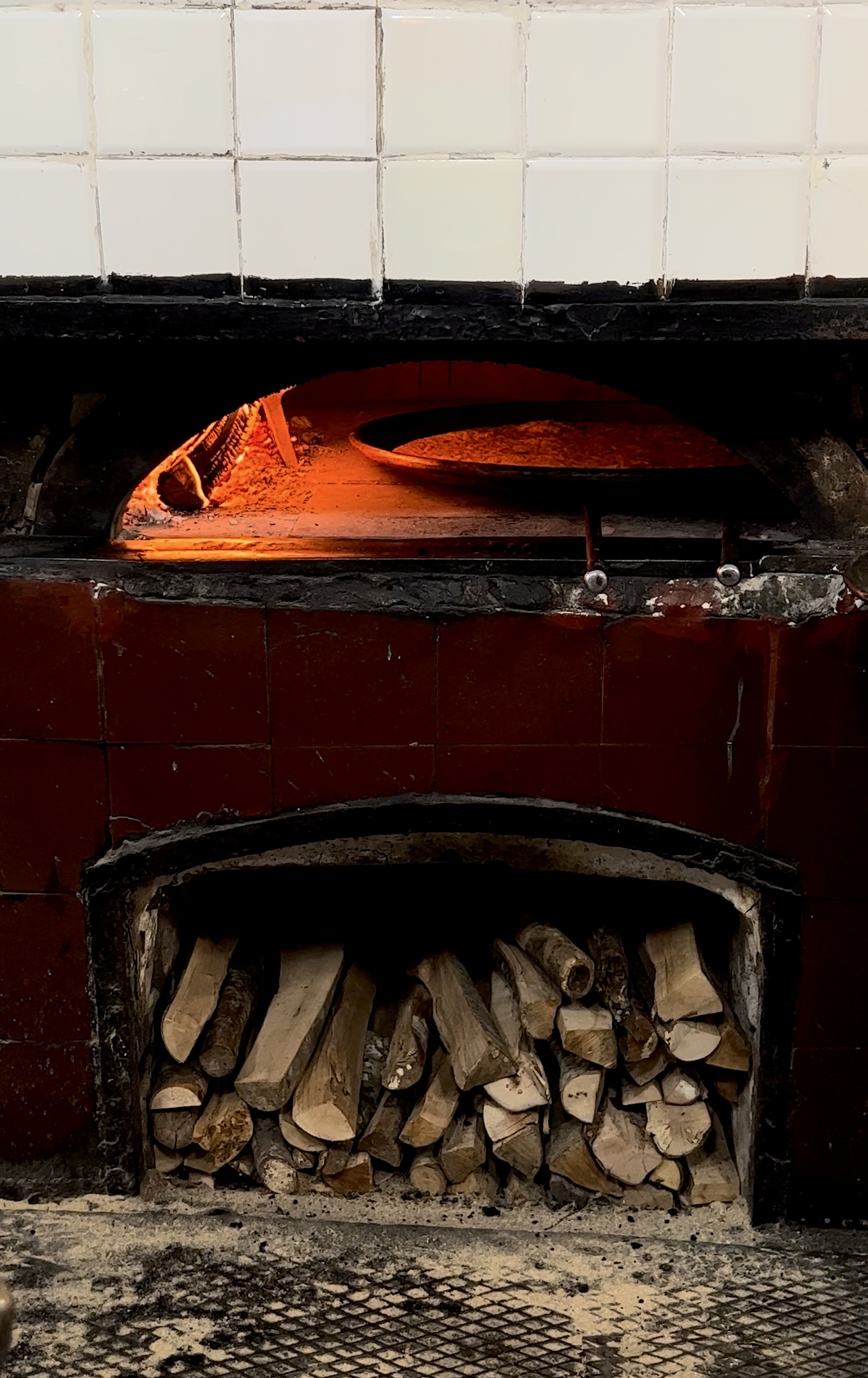 an image of farinata–chickpea pancake–cooking in a woodfired ovenred oven