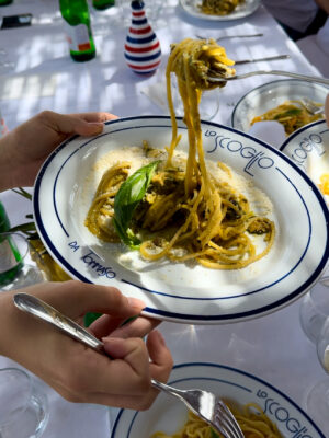 an image of someone taking a forkful of spaghetti alla nerano