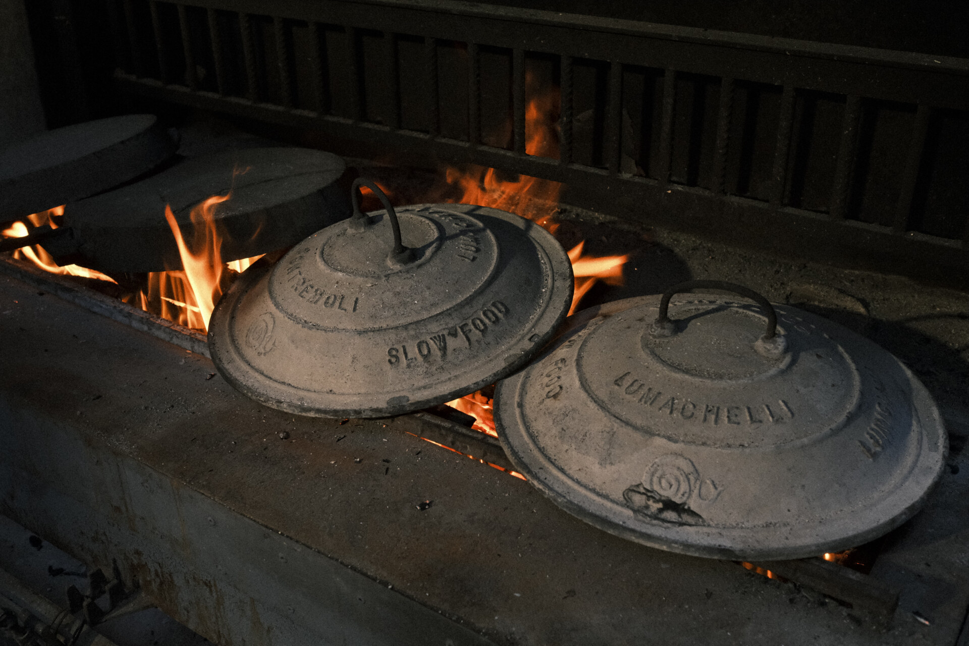 Heating up the testo soprano–large cast iron skillets–at La Vecchia Cascina