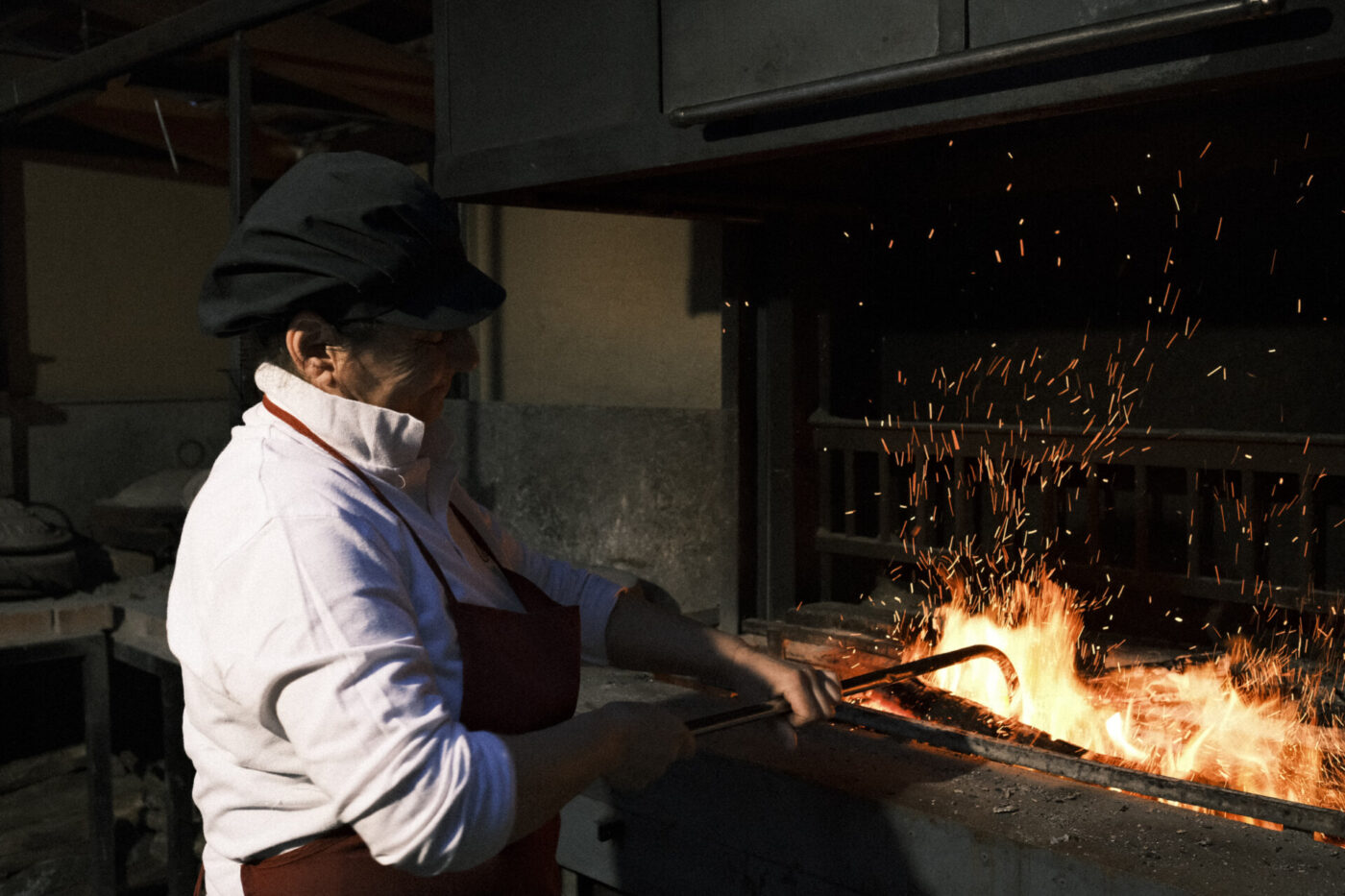 Katia tending the fire to make testaroli at La vecchia cascina