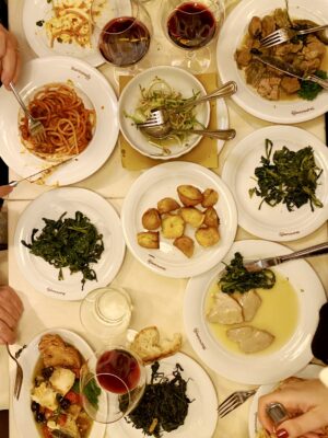 an overhead image of a spread of food and pasta in Rome at Matricianella