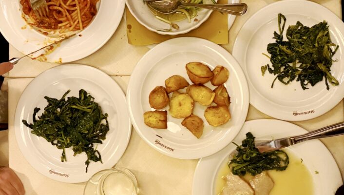 an overhead image of a spread of food and pasta in Rome at Matricianella
