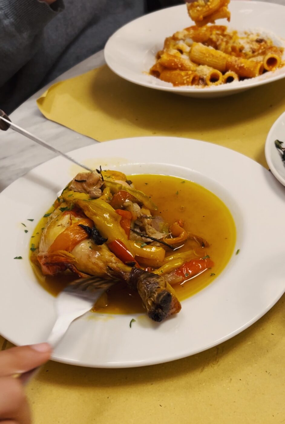 someone cutting into a leg of Pollo con i peperoni