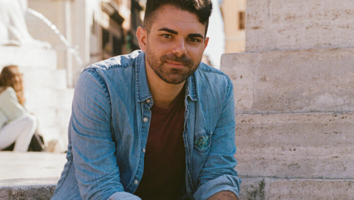 an image of Amir sitting on the side of a fountain