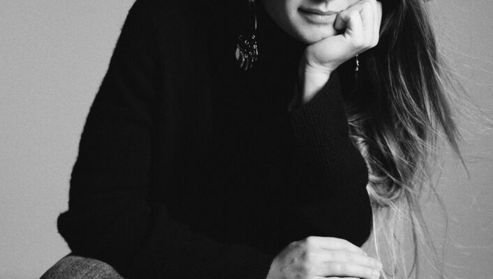 a black and white image of annagreta panconesi sitting and leaning her head on her chin