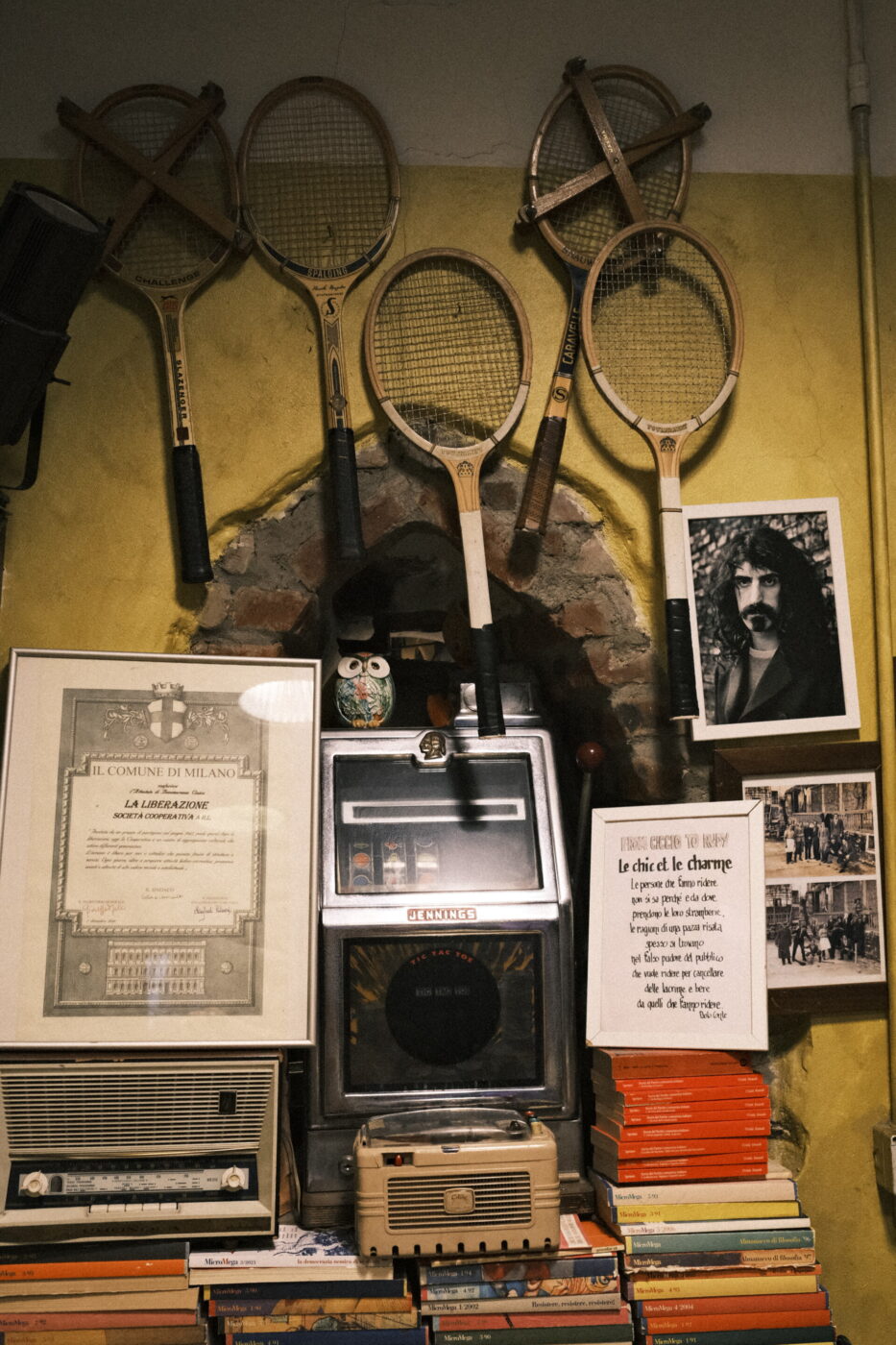 the inside of a cooperative with old racquettes and posters