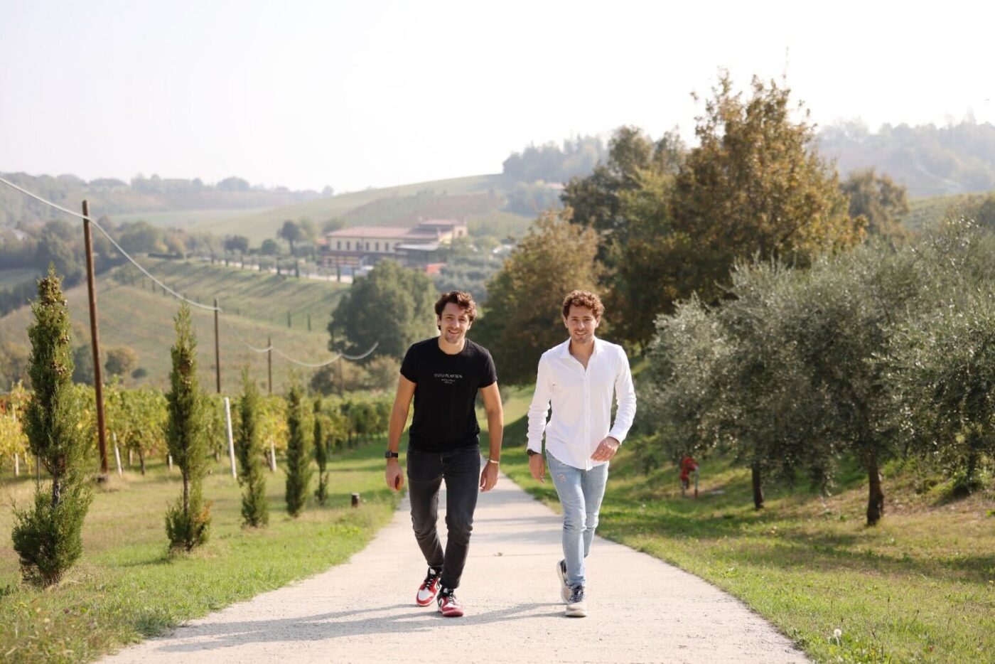 Two brothers walking down a countryside road in Modena