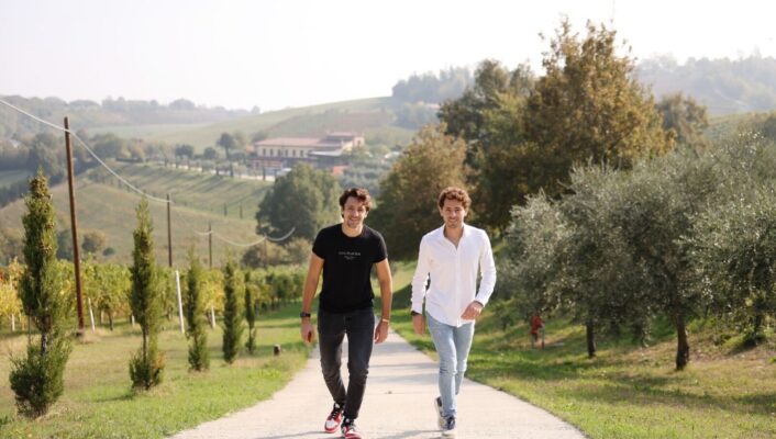 Two brothers walking down a countryside road in Modena