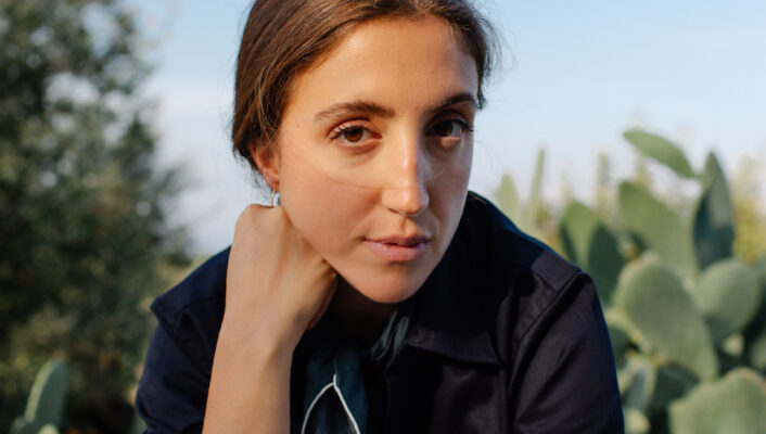 an image of a chef Giorgia sitting in front of cactus plants in Puglia