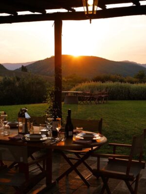 an image of tenita di murlo with a table outside at sunset