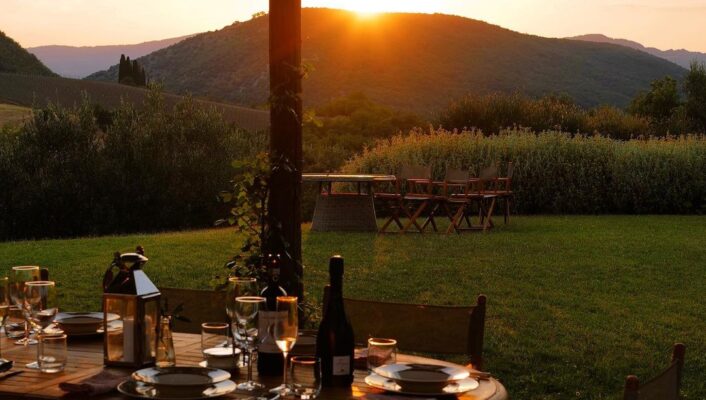 an image of tenita di murlo with a table outside at sunset