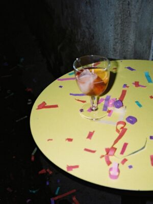 a yellow tables with spritz and confetti at SI MA Townhouse in Milan
