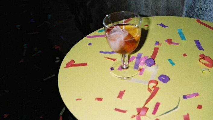 a yellow tables with spritz and confetti at SI MA Townhouse in Milan