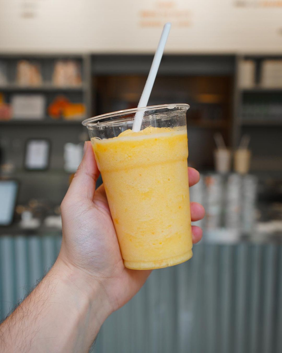 a fruit granita in a cup with a straw from Pavè in Milan