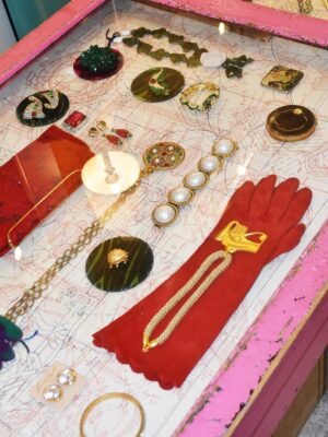 a case filled with vintage jewelry, cloves, and more at Cavalli e Nastri in milan