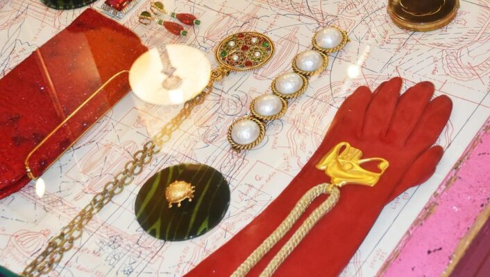 a case filled with vintage jewelry, cloves, and more at Cavalli e Nastri in milan