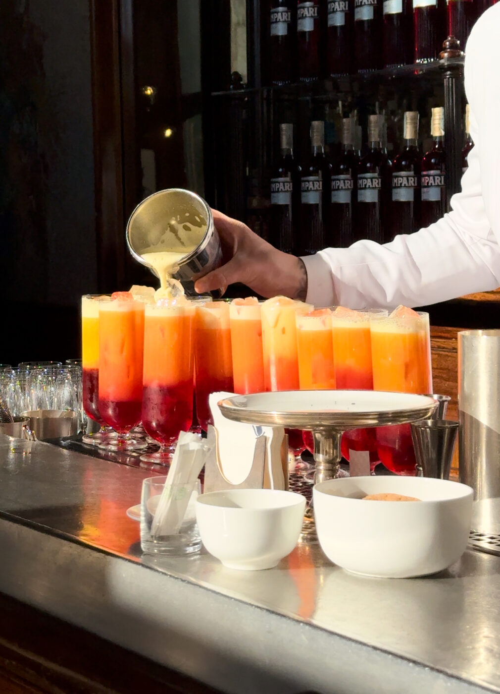 a counter full of frothy garibaldi cocktails at camparino in milan
