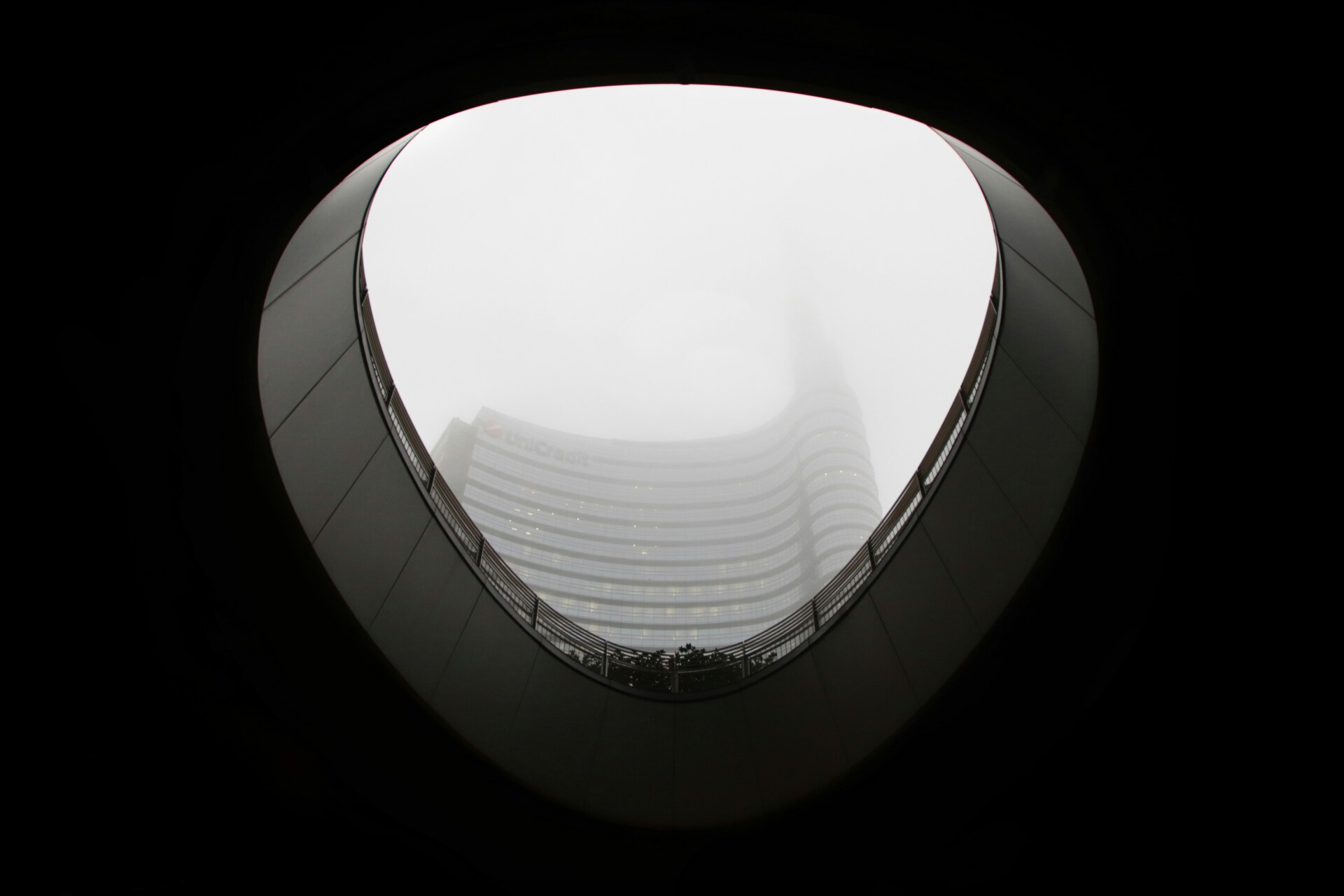 an image of milan showing a misty skyscraper