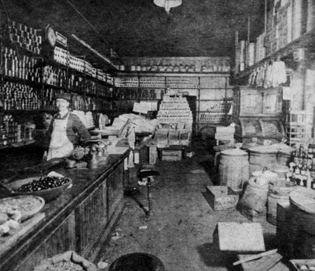 Central Grocery, New Orleans, interior view, 1906. Shopkeeper Salvatore Lupo seen behind the counter; he is credited with inventing the muffuletta (sandwich) here this year.