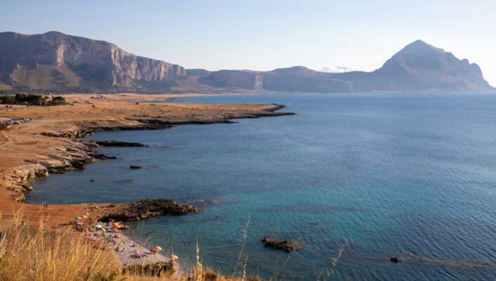 the blue sea with mountains in the backdrop in the province of trapani sicily