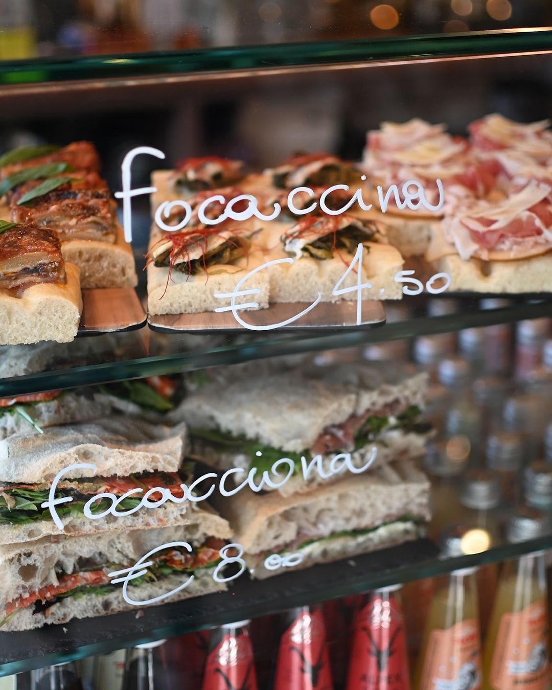 a window at Ozio wine bar with focacciona and focaccina on offer