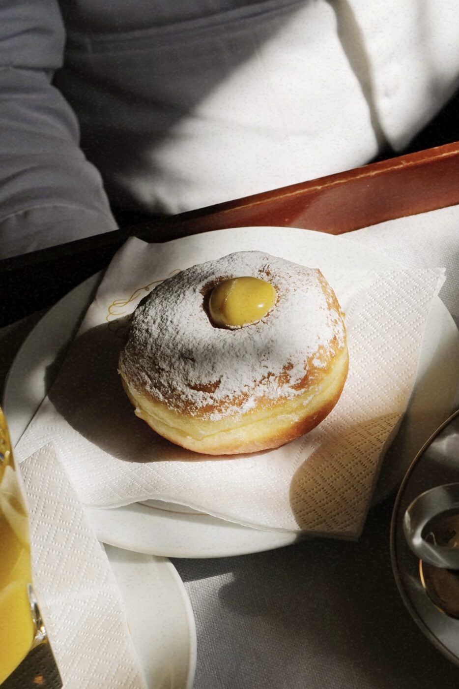 a platter with a single cream filled bomboloni