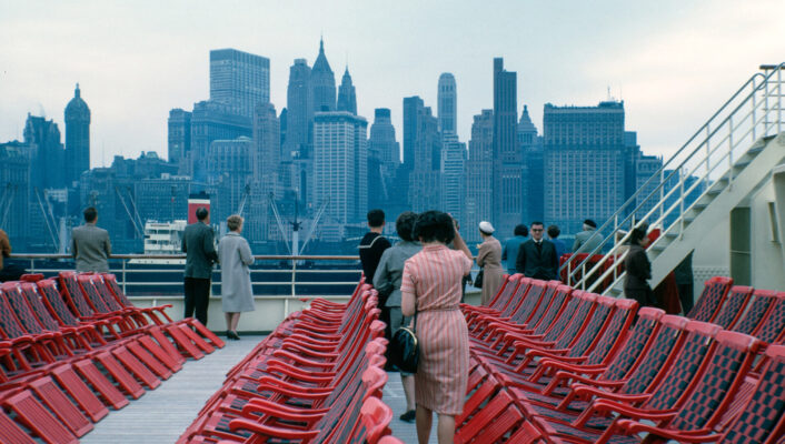 vintage image of people on the staten island ferry with a view towards downtown manhattan