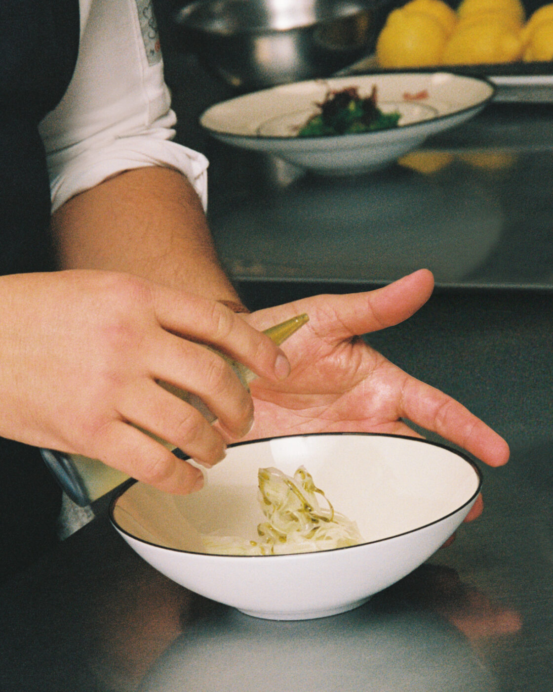 putting the final touches on a dish at Gucci Osteria