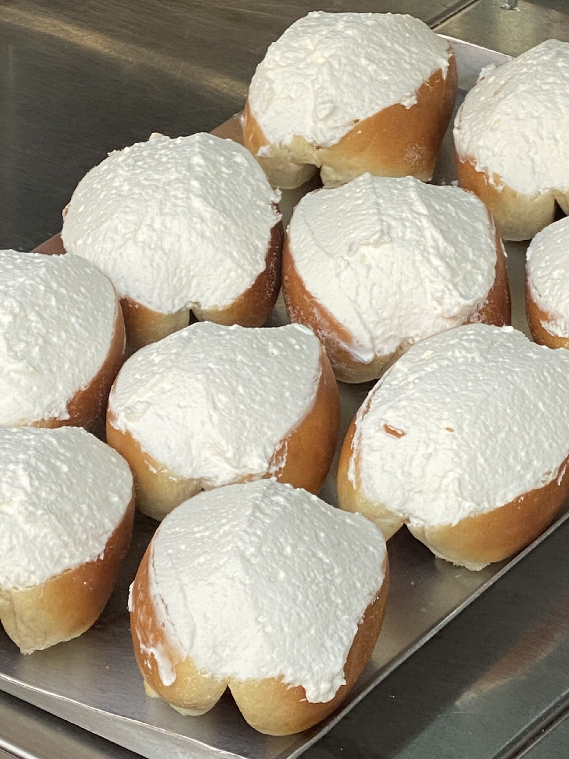 a silver tray of maritozzi