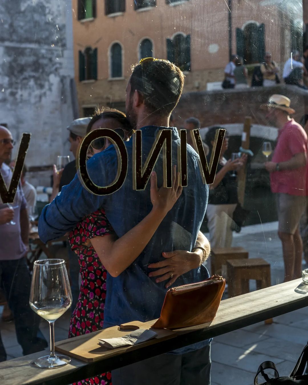Vino Vero wine bar - wine with couple hugging outside