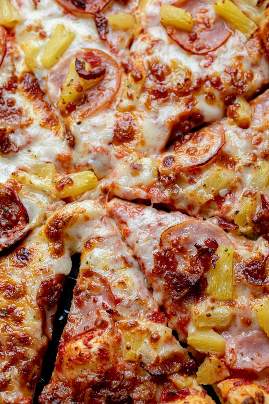 a close up image of a pizza with pineapple on it