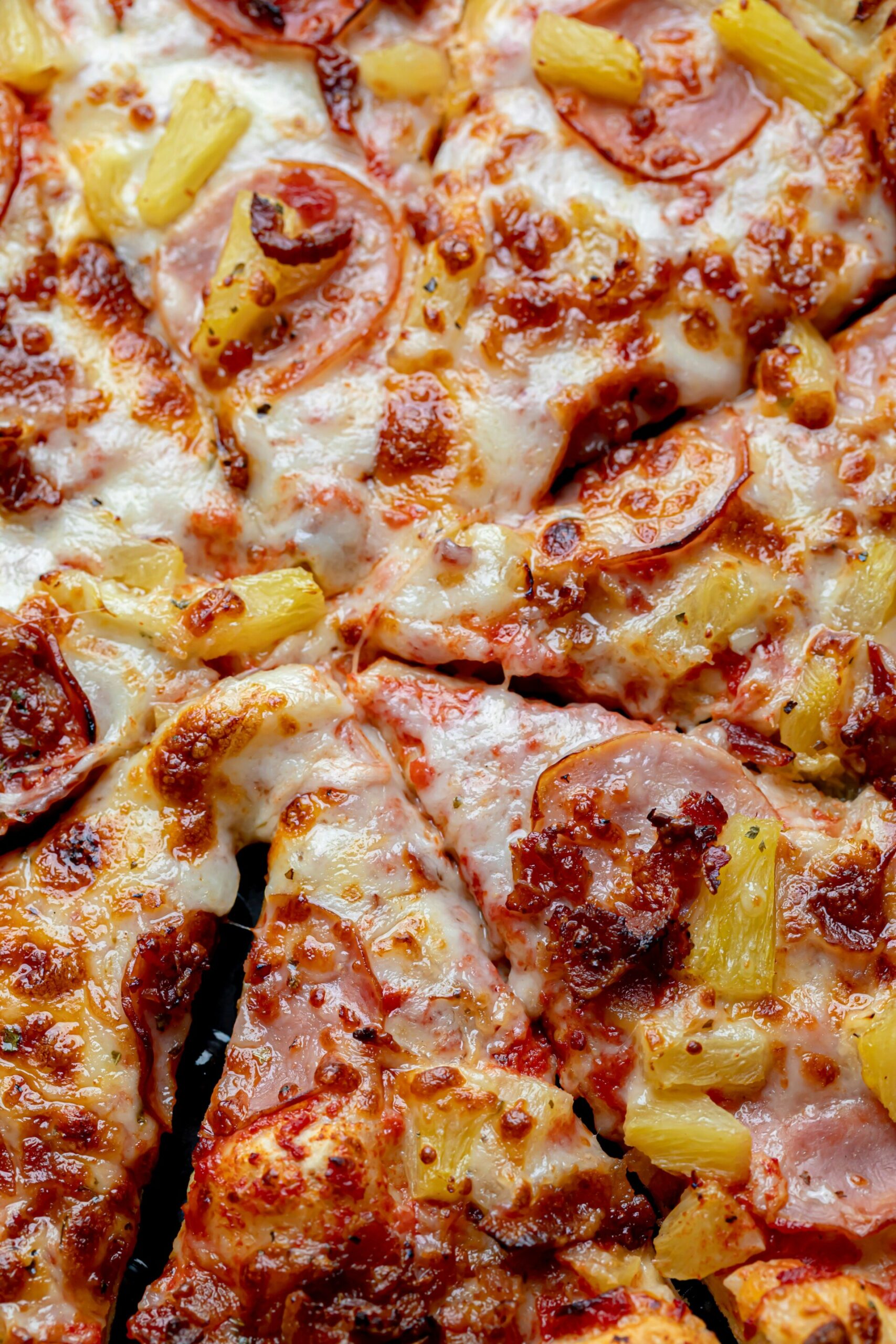 a close up image of a pizza with pineapple on it