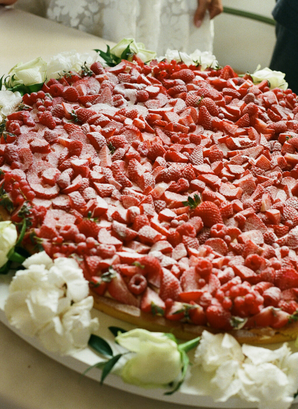 a giant wedding cake covered in strawberries