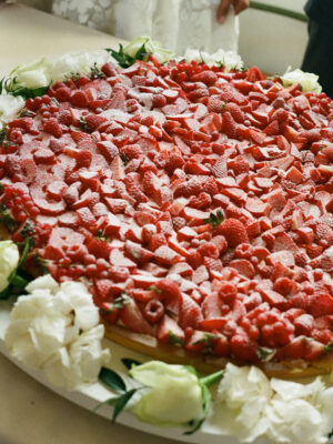 a giant wedding cake covered in strawberries