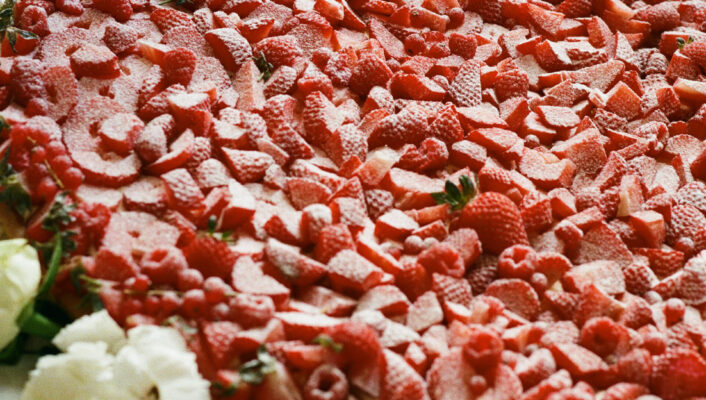 a giant wedding cake covered in strawberries