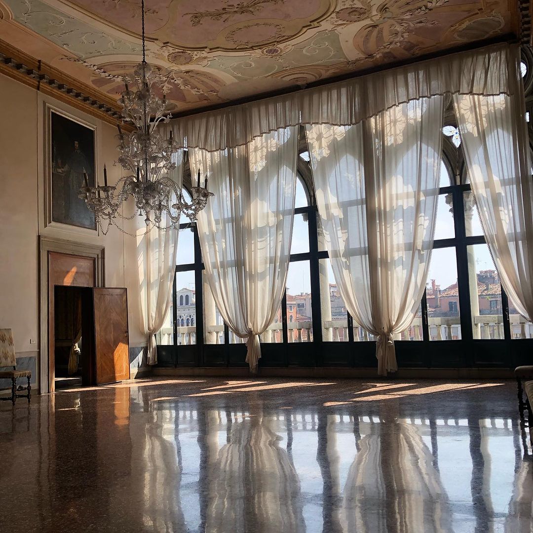 a large ballroom at Palazzo Pisani with windows looking into the grand canal