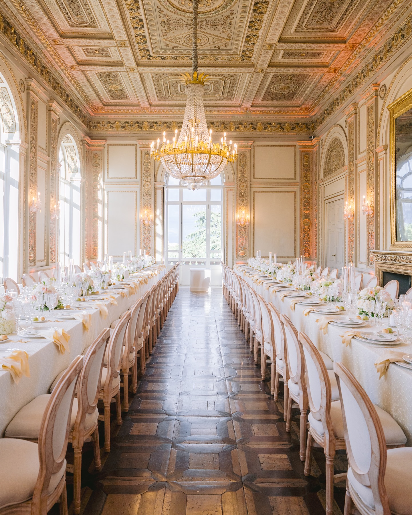 two long imperial tables at villa aurelia set for weddings inside the frescoed room