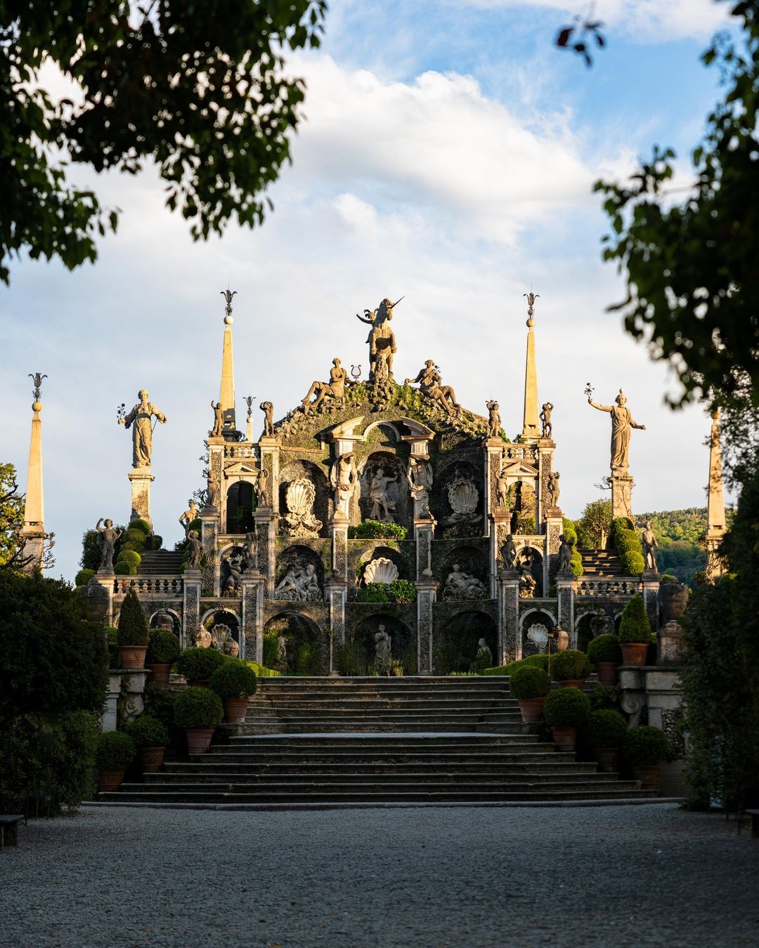 a giant vine covered collection of statues creating a shrine on terre borromeo in lake maggiore