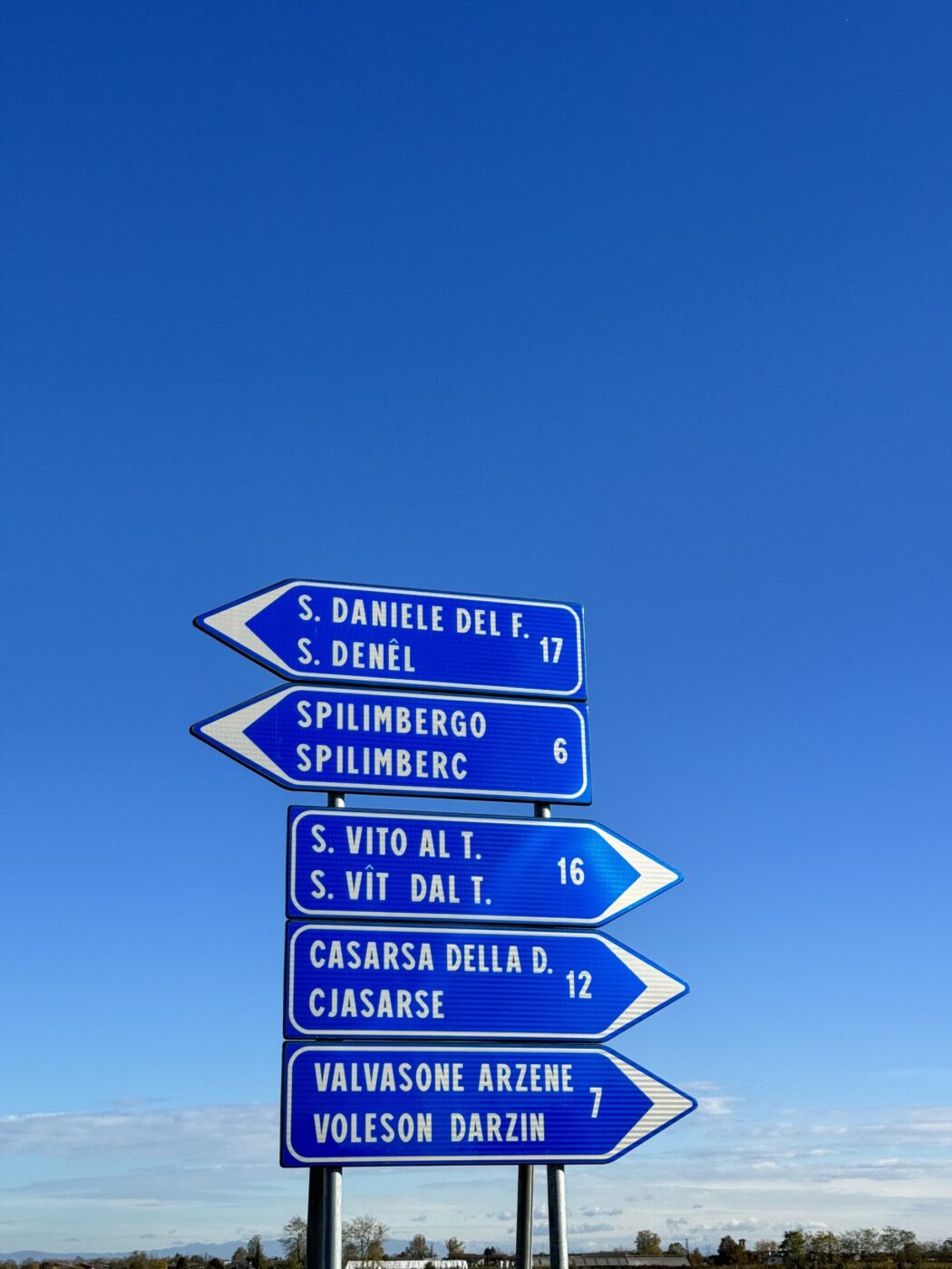 road signs in Friuli pointing to San Daniele, a geographical indication area for prosciutto