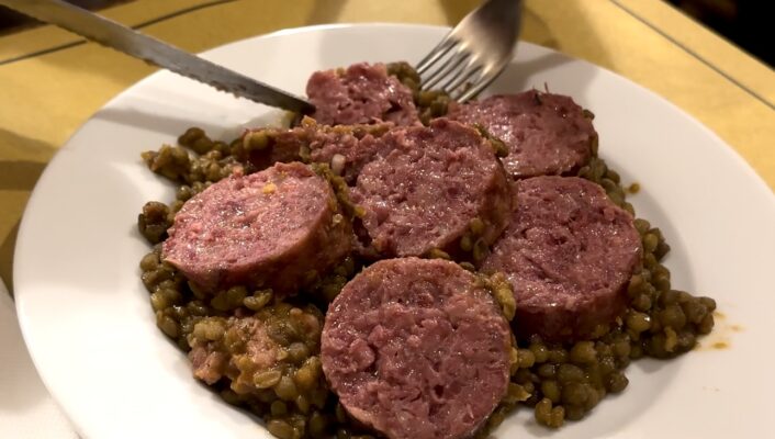 a plate of zampone on lentils in Italy