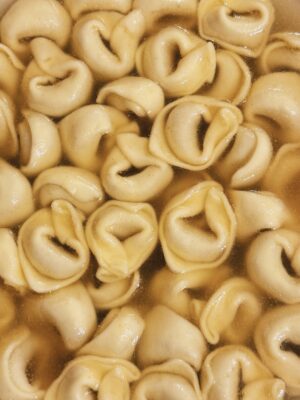 a close up image of tortellini in brodo