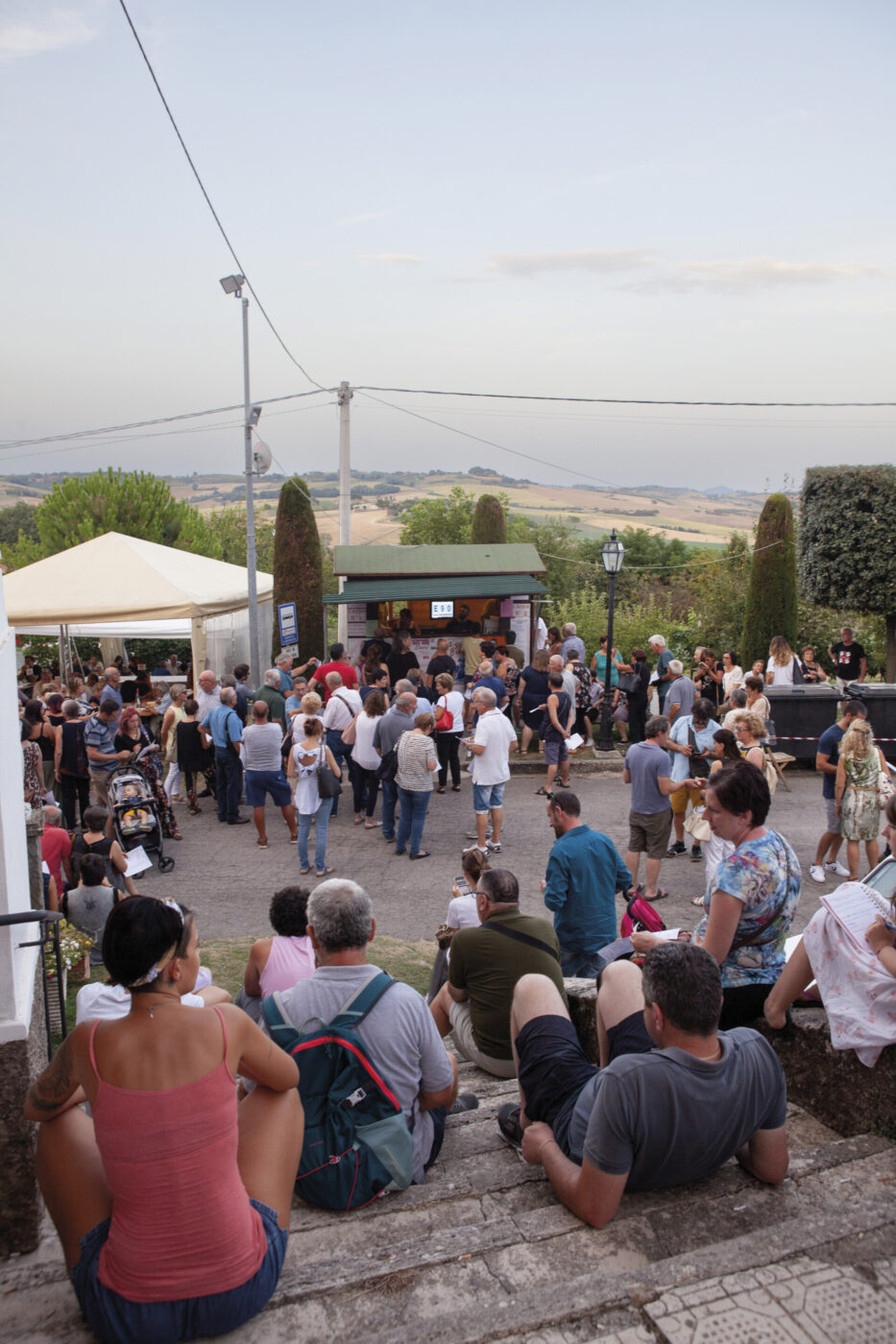 people crowding and lining up and eating at the sagra del pesce in Umbria
