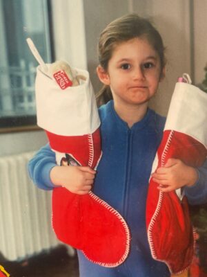 an image of a young girl holding two stockings