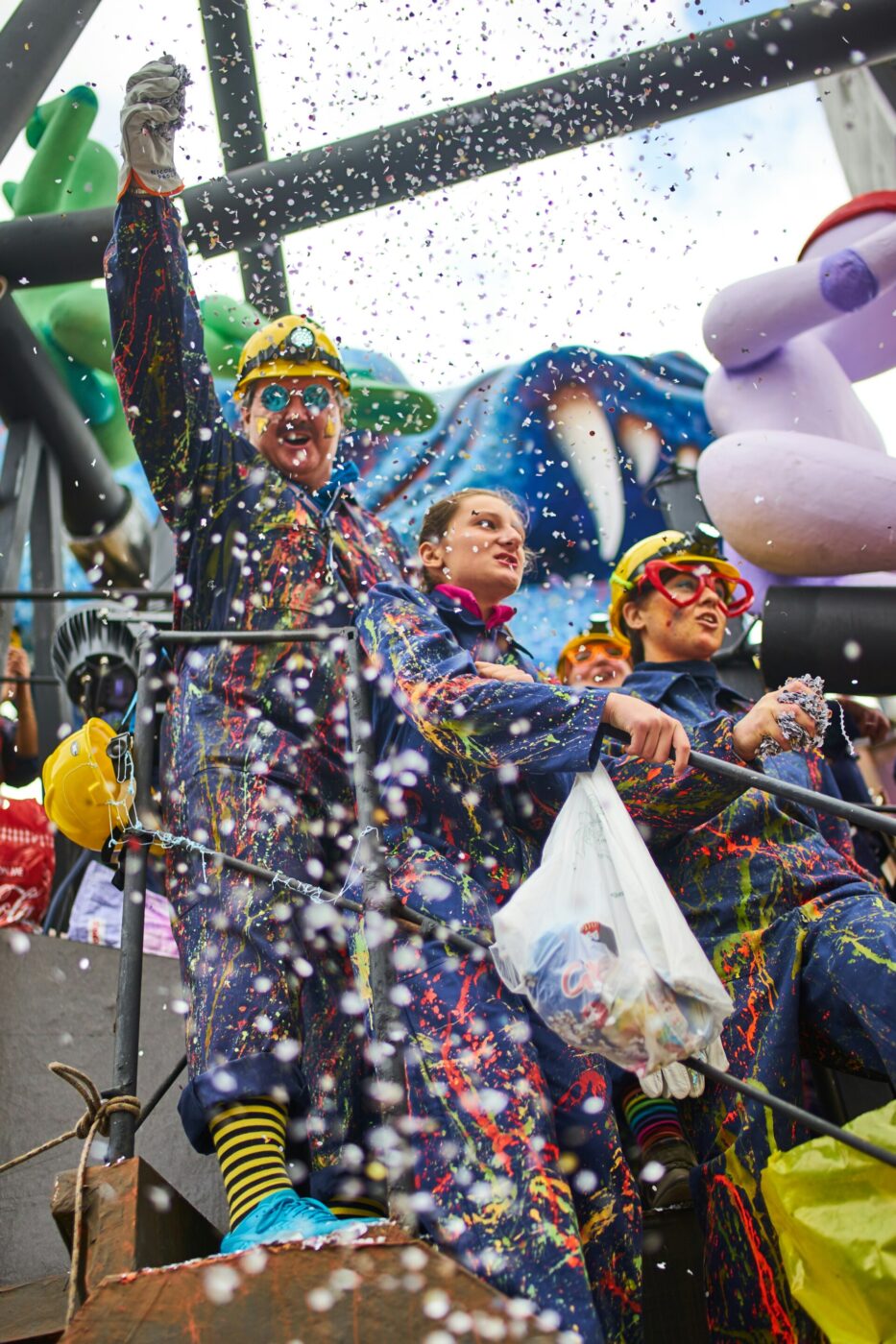 a float at venice's carnevale with confetti being thrown down
